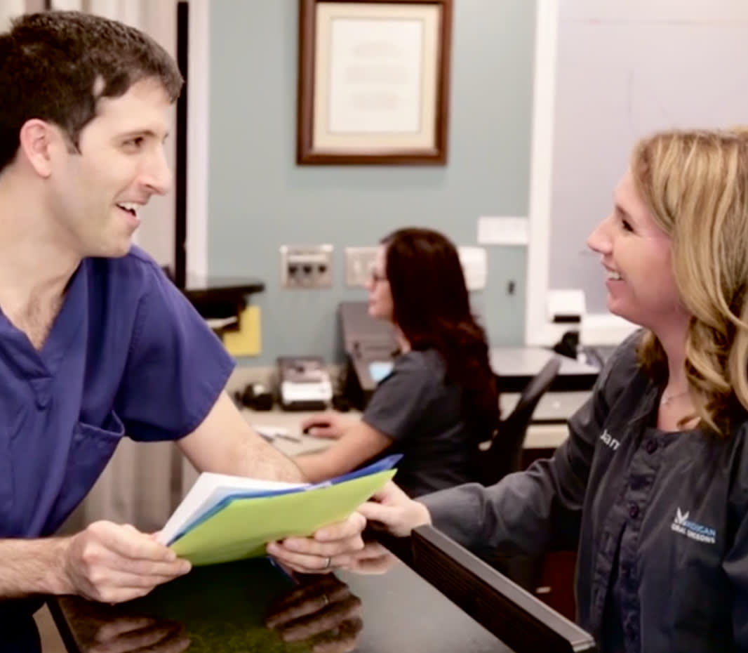 Dr. Fasi talking to front desk staff