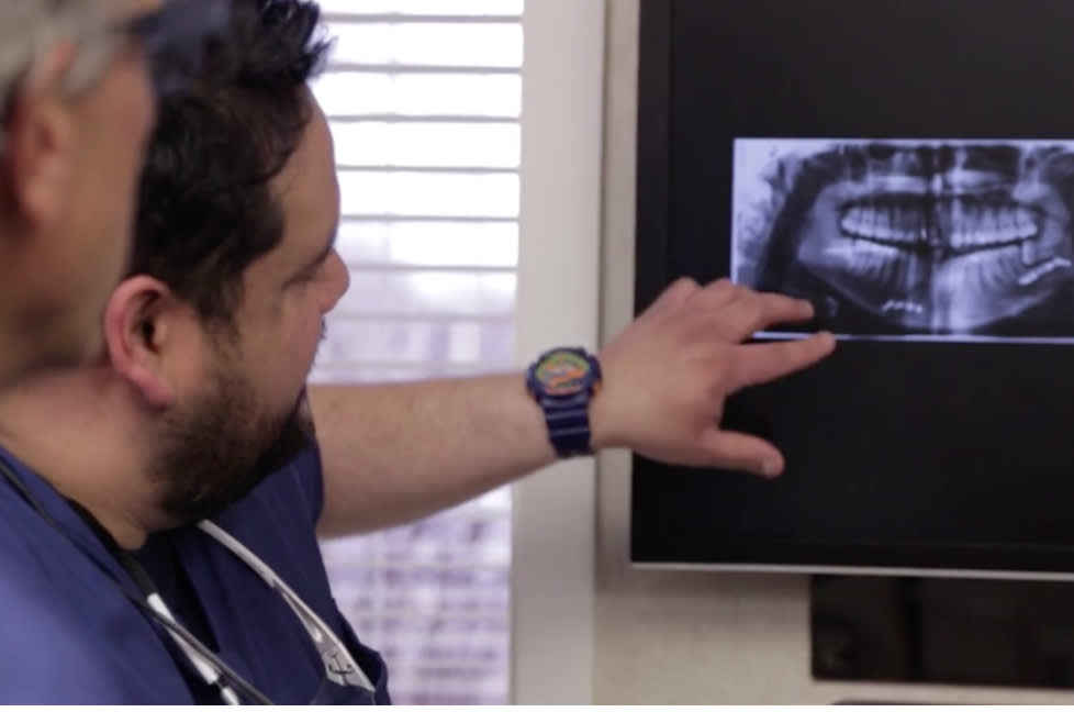 Oral surgeons looking at an X-ray